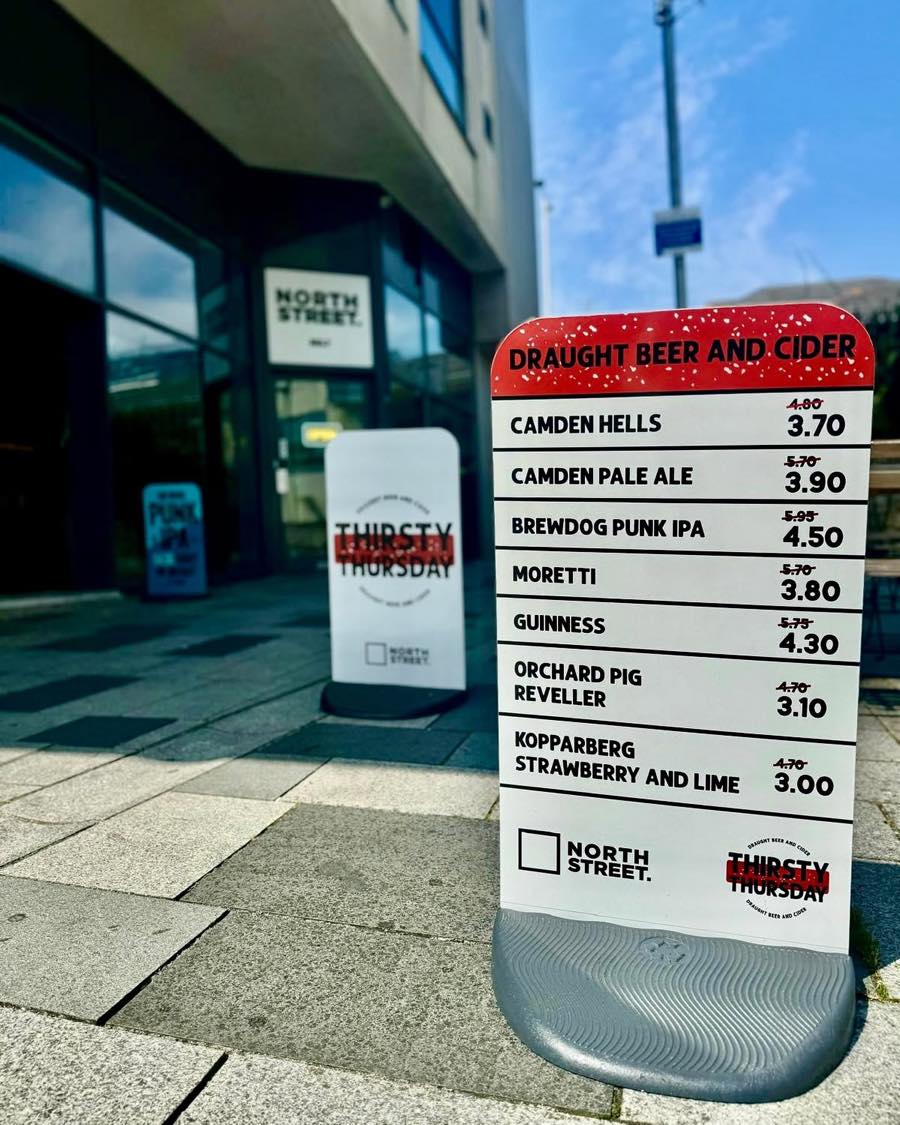 The Thirsty Thursday board outside North Street No.7, listing draught beer and cider prices
